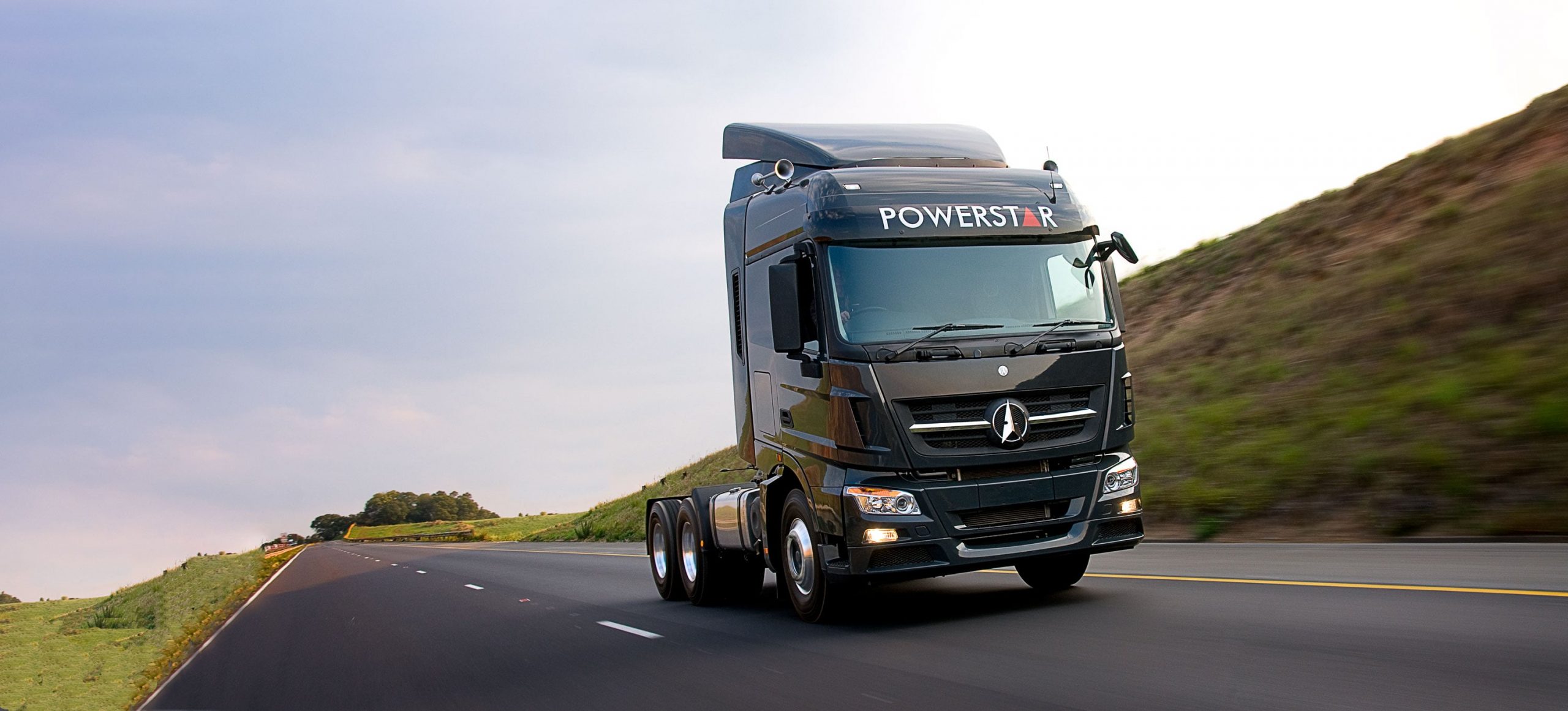 Black Powerstar truck tractor on a highway